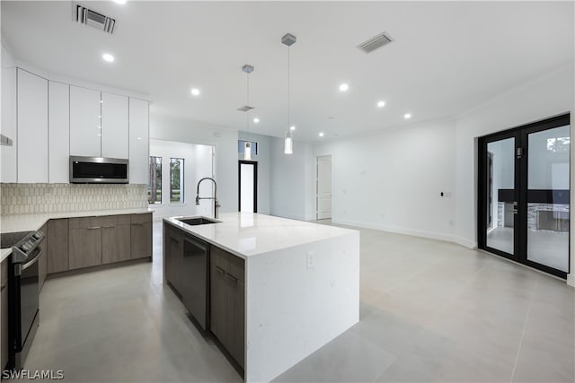 kitchen with pendant lighting, a kitchen island with sink, white cabinetry, backsplash, and stainless steel appliances