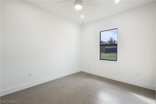 tiled empty room featuring ceiling fan