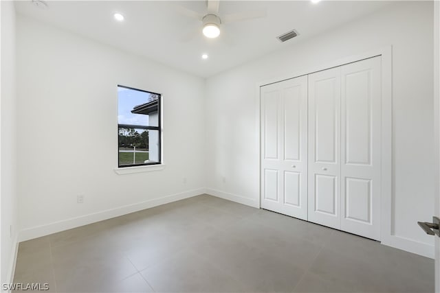 unfurnished bedroom featuring a closet, tile flooring, and ceiling fan