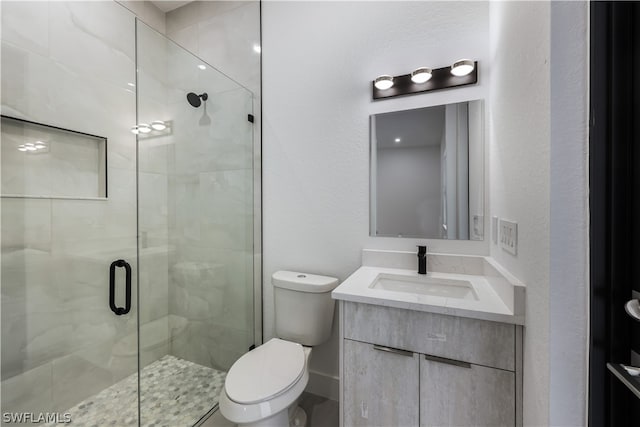 bathroom featuring walk in shower, vanity, and toilet