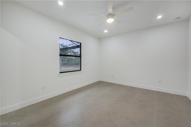 tiled spare room featuring ceiling fan