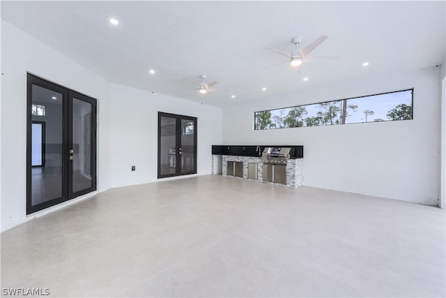 unfurnished living room with ceiling fan, french doors, and light tile floors