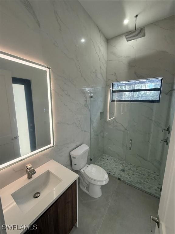 bathroom featuring vanity, toilet, and an enclosed shower