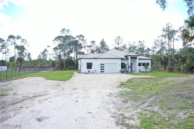 view of front of house featuring a garage and a front yard