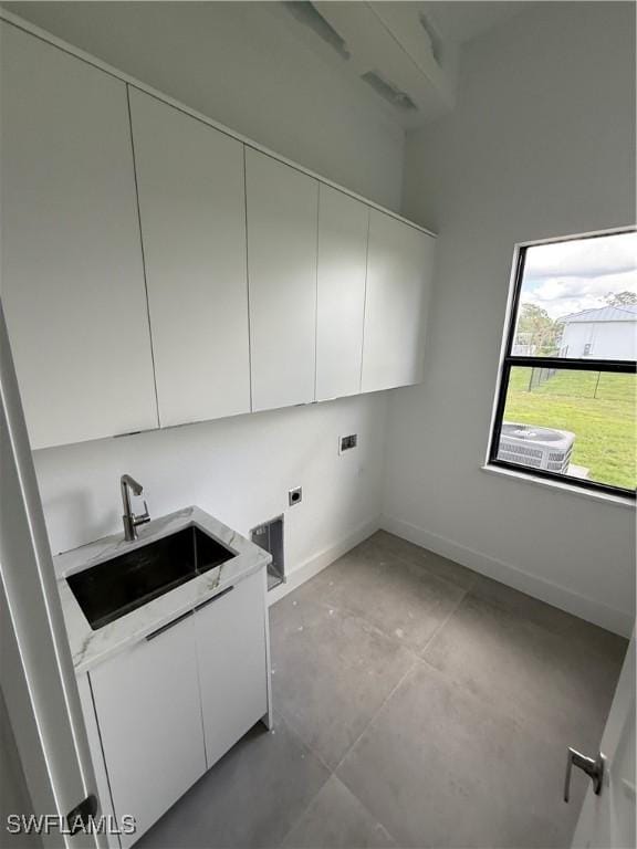 laundry area with cabinets, washer hookup, hookup for an electric dryer, and sink