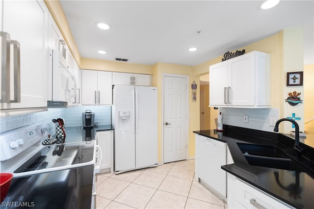 kitchen featuring sink, white cabinetry, light tile patterned floors, white appliances, and decorative backsplash