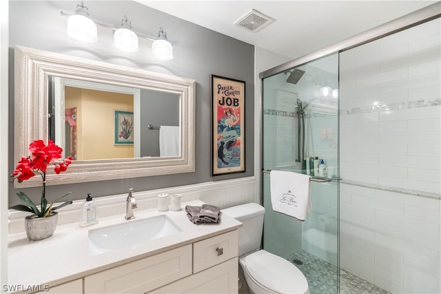 bathroom with vanity, toilet, and an enclosed shower