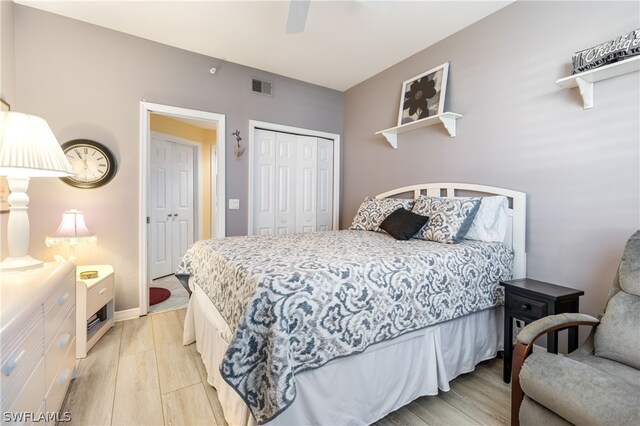 bedroom with a closet, ceiling fan, and light wood-type flooring