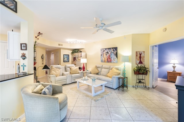 living room featuring ceiling fan and light tile floors