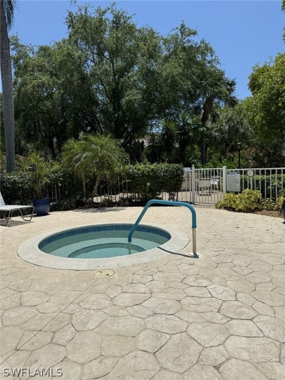 view of swimming pool with a community hot tub and a patio area