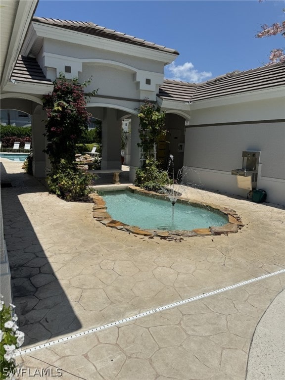 view of pool featuring a patio