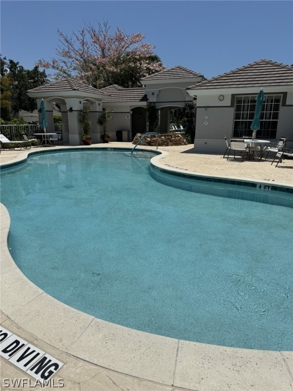 view of swimming pool with a patio