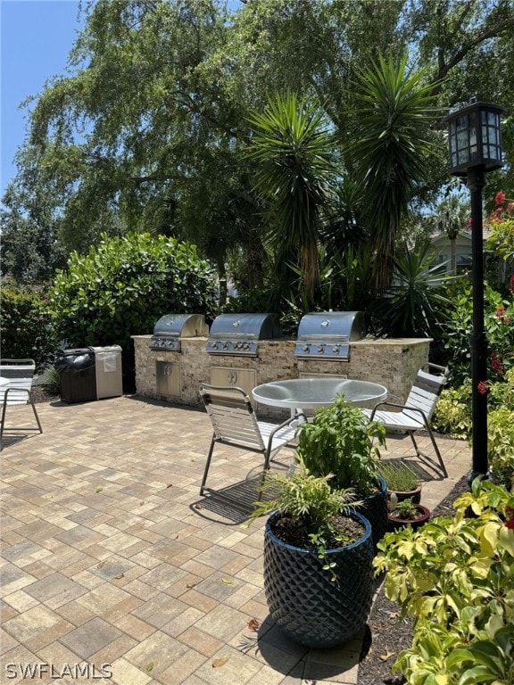 view of terrace featuring a grill and an outdoor kitchen