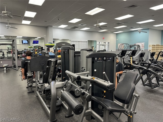 workout area with a wealth of natural light, ceiling fan, and a drop ceiling