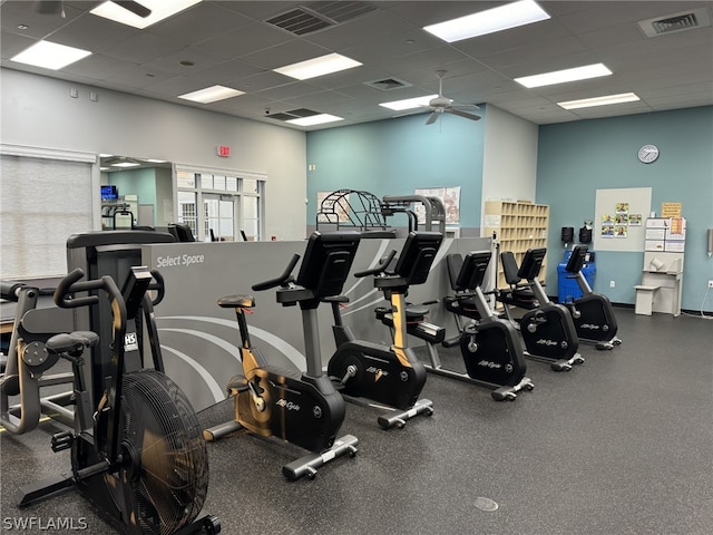 exercise room featuring ceiling fan and a drop ceiling