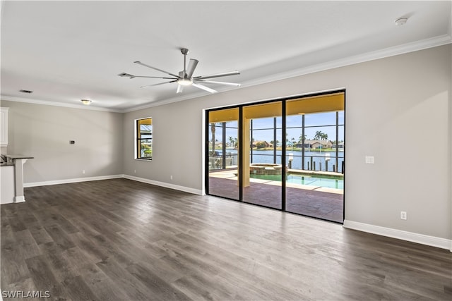 spare room featuring ceiling fan, dark wood-type flooring, and ornamental molding