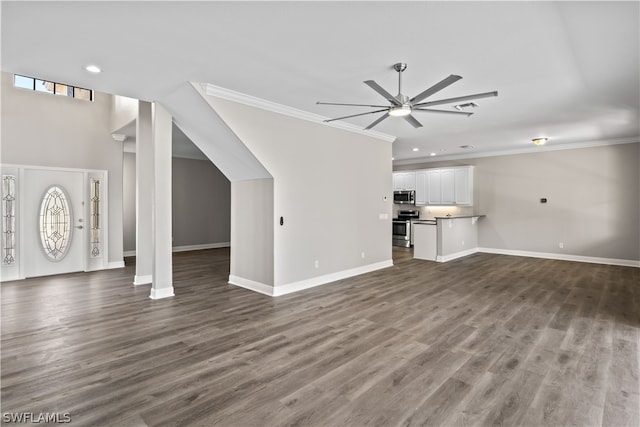 unfurnished living room featuring hardwood / wood-style floors, ceiling fan, ornamental molding, and plenty of natural light