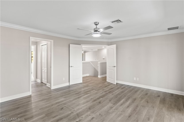 unfurnished bedroom featuring ornamental molding, ceiling fan, and hardwood / wood-style flooring