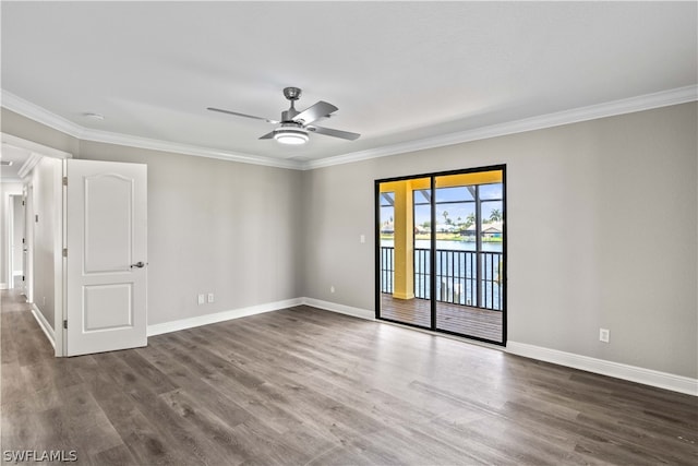 empty room featuring ornamental molding, ceiling fan, and dark hardwood / wood-style floors