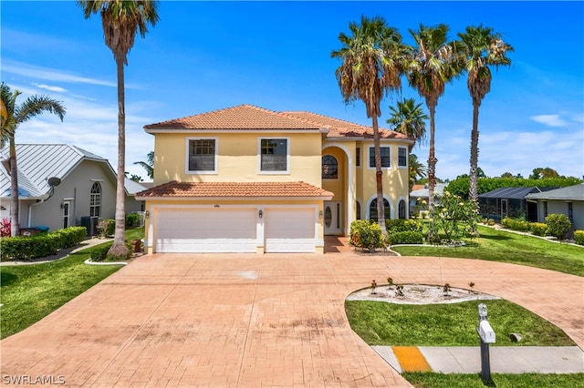 mediterranean / spanish-style house featuring a garage and a front yard