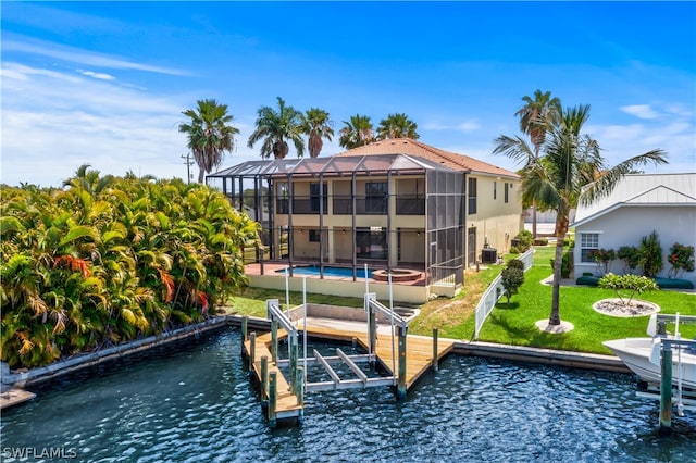 view of dock with a lanai and a yard