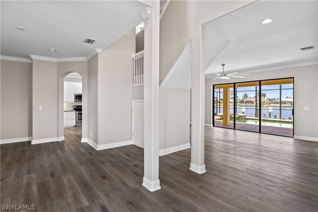 interior space with crown molding, dark hardwood / wood-style flooring, ceiling fan, and a water view