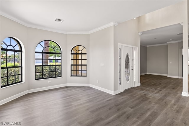 unfurnished room featuring a healthy amount of sunlight, crown molding, and dark hardwood / wood-style floors