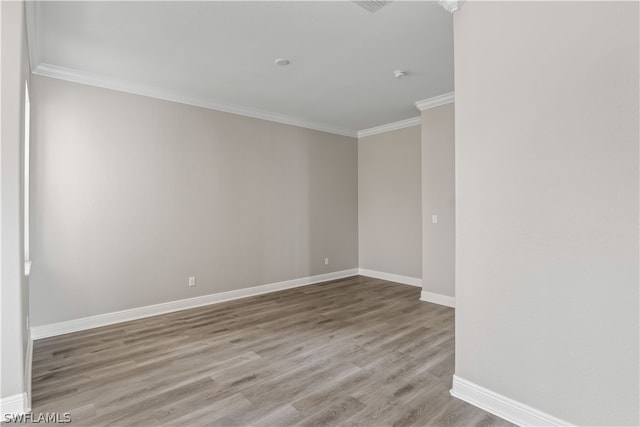 unfurnished room with wood-type flooring and crown molding