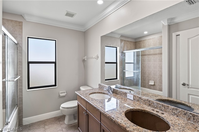 full bathroom featuring crown molding, dual vanity, combined bath / shower with glass door, tile flooring, and toilet