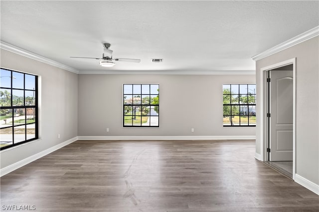 unfurnished room featuring ornamental molding, plenty of natural light, dark wood-type flooring, and ceiling fan