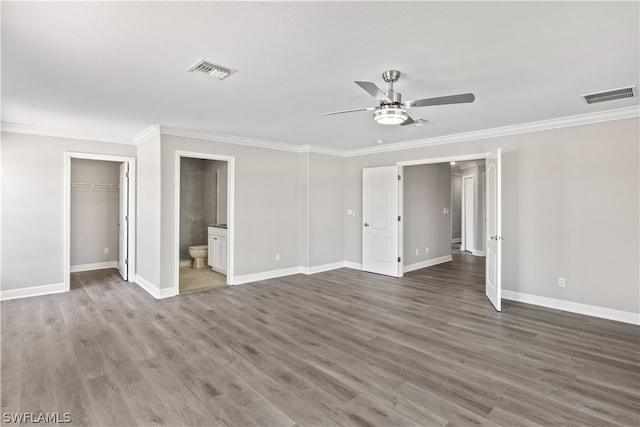 unfurnished bedroom with wood-type flooring, ceiling fan, crown molding, and connected bathroom