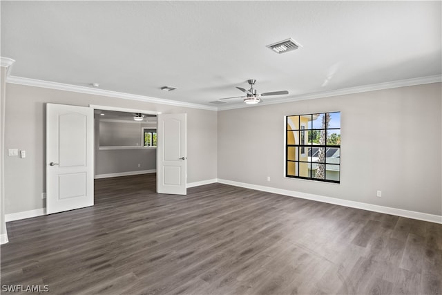 spare room featuring plenty of natural light, crown molding, dark wood-type flooring, and ceiling fan