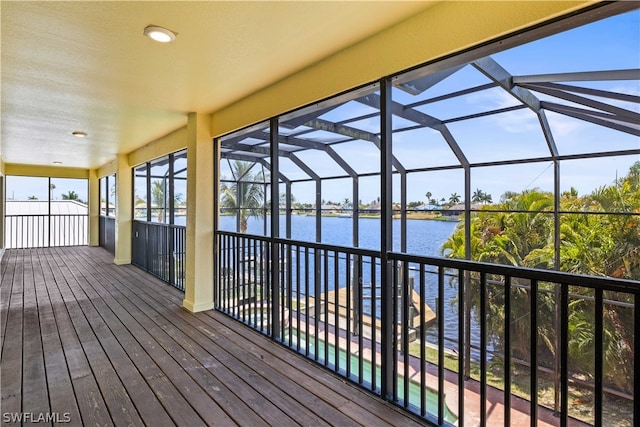 wooden deck featuring a water view and glass enclosure