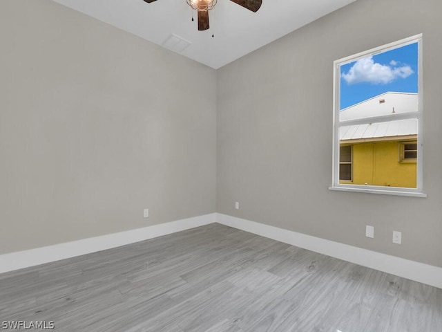 spare room featuring hardwood / wood-style flooring and ceiling fan