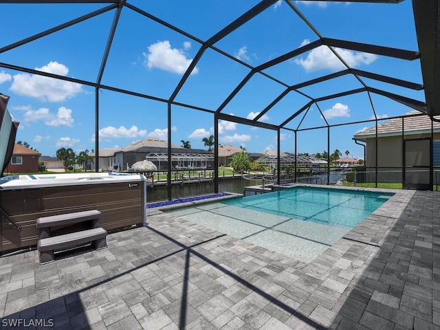 view of pool featuring a patio area, a lanai, a water view, and a hot tub