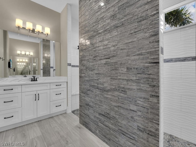 bathroom featuring vanity and tile walls