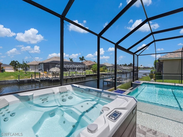 view of swimming pool featuring a dock, a water view, a hot tub, and a lanai