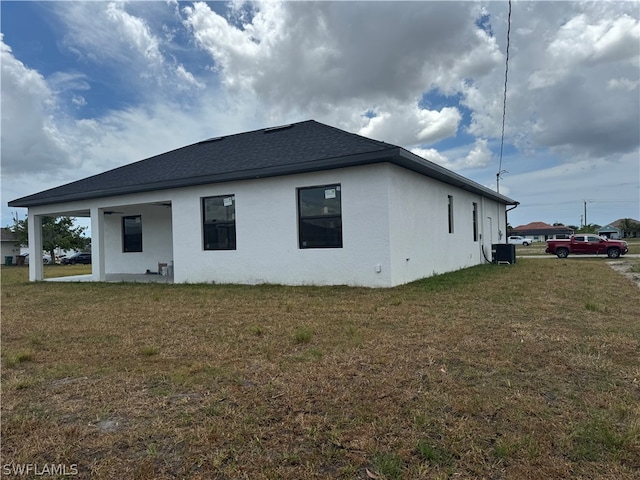 rear view of property featuring a lawn