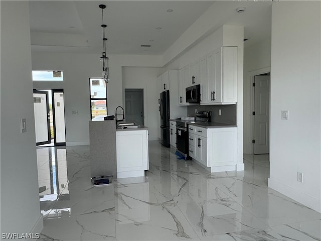 kitchen featuring pendant lighting, black fridge, light tile floors, electric range oven, and white cabinetry