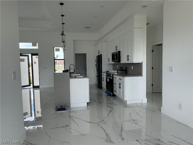 kitchen featuring white cabinets, electric stove, freestanding refrigerator, marble finish floor, and a sink