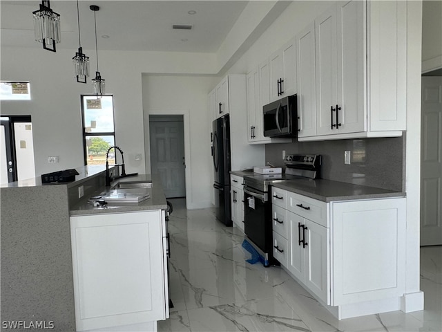 kitchen with electric stove, decorative light fixtures, light tile floors, sink, and white cabinets