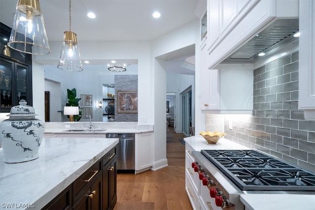 kitchen with stove, white cabinets, light hardwood / wood-style flooring, backsplash, and dishwasher