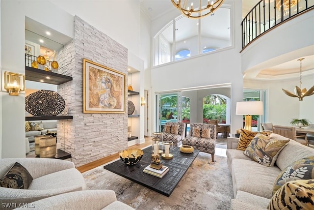 living room featuring hardwood / wood-style floors, a high ceiling, and a chandelier