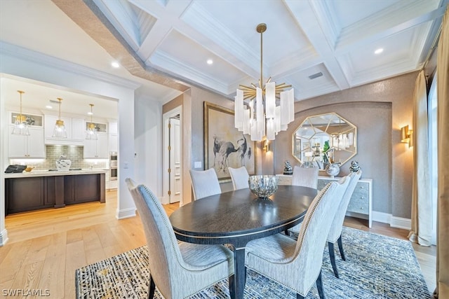 dining area with coffered ceiling, a notable chandelier, beam ceiling, ornamental molding, and light hardwood / wood-style flooring