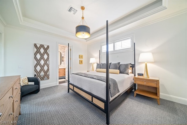 bedroom with a raised ceiling, dark colored carpet, and crown molding