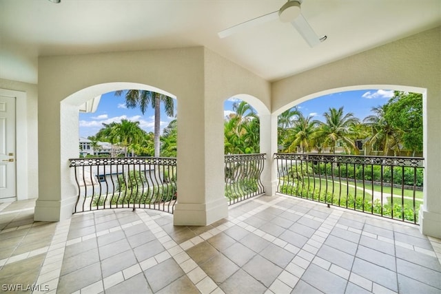 view of patio / terrace with ceiling fan and a balcony