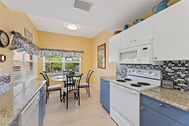 kitchen featuring blue cabinets, tasteful backsplash, white cabinetry, light stone countertops, and white appliances