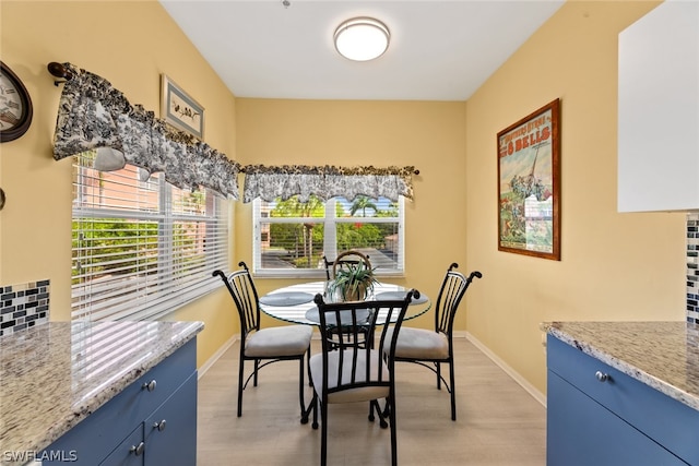 dining space with light wood-type flooring