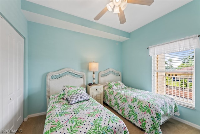 bedroom with ceiling fan, a closet, and dark carpet