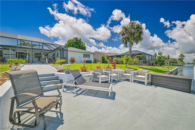 view of patio / terrace featuring a lanai and a water view